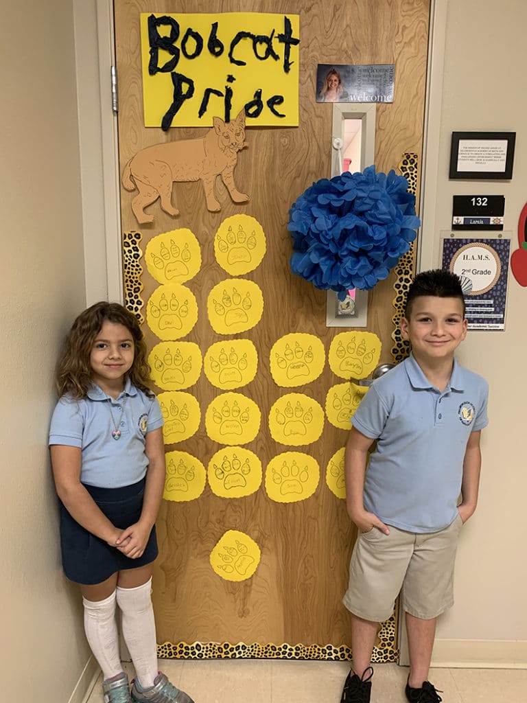 students-stand-by-decorated-door